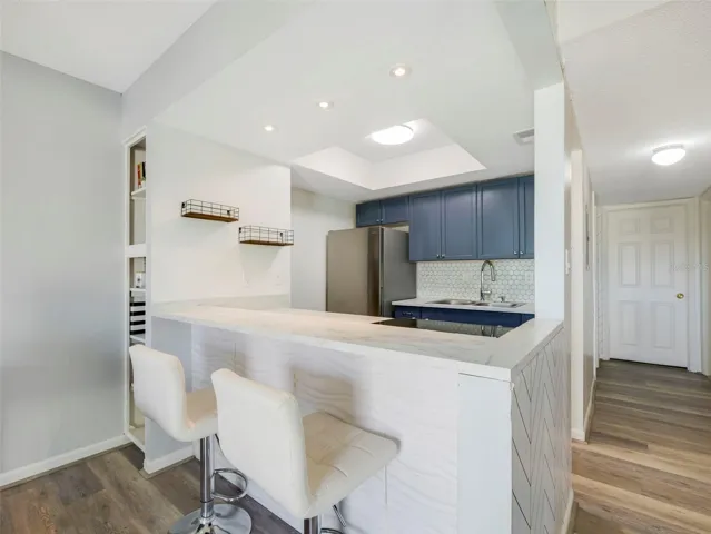 With room for counter-height stools, the Kitchen island doubles as a comfortable spot for quick meals or gathering with guests.