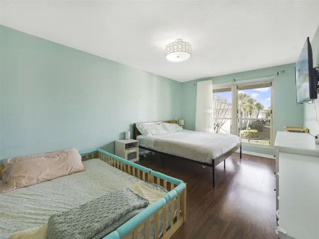 Large windows bathe the Primary Suite with soft, natural light, creating a serene start to your day.