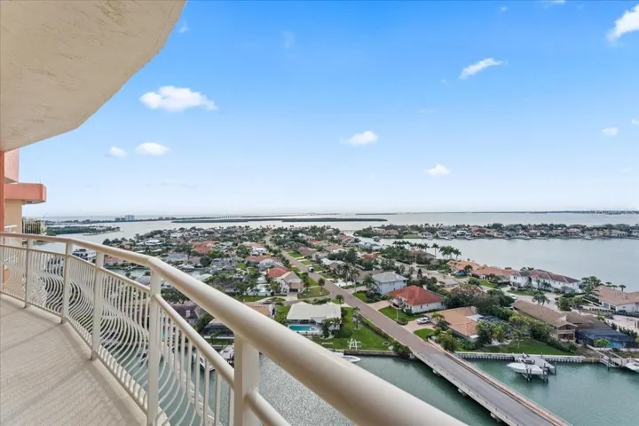 East-facing balcony view with wide-open water and skyline backdrops.
