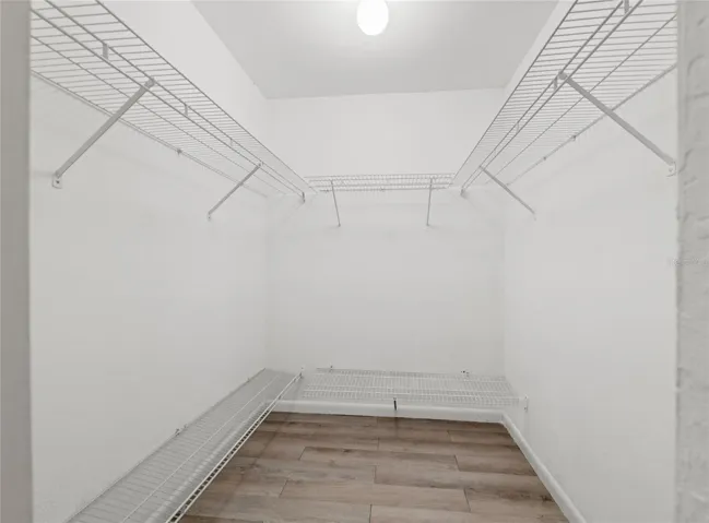 Primary bedroom walk in closet