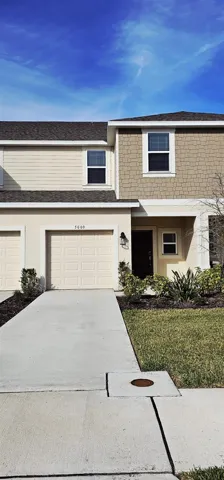 Front exterior with private, one car garage and gcovered front porch.