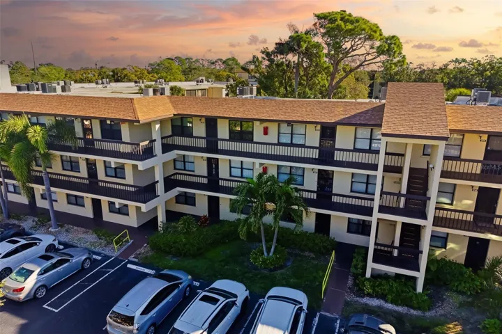 Building Aerial (Sunset Tone)Aerial view of DeSoto Square Villas showcasing well-maintained buildings and mature landscaping