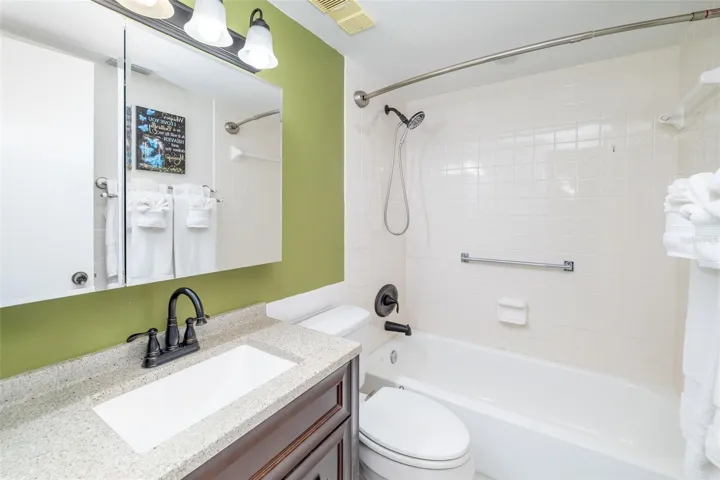 Updated guest bathroom with modern vanity and tub/shower combination