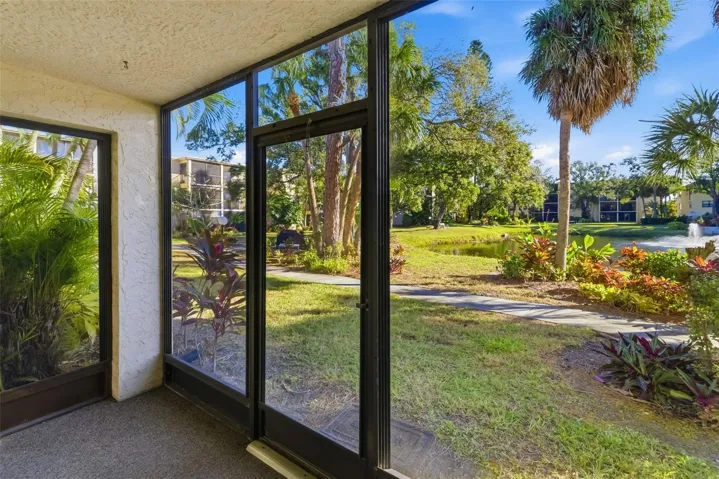 Private screened lanai with peaceful garden and pond views – ideal for enjoying Florida outdoor living year-round