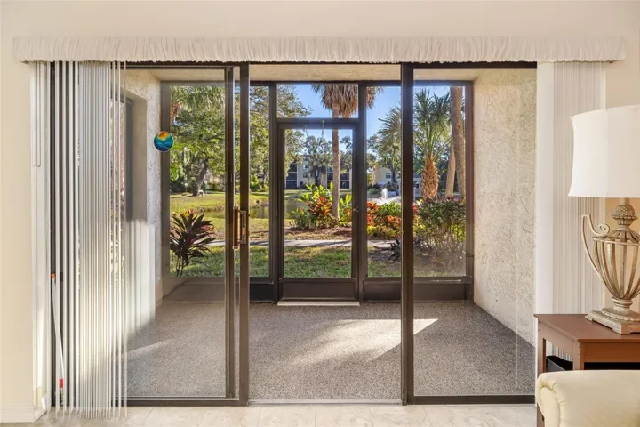 Relaxing enclosed lanai with tranquil pond and landscaping views in DeSoto Square Villas
