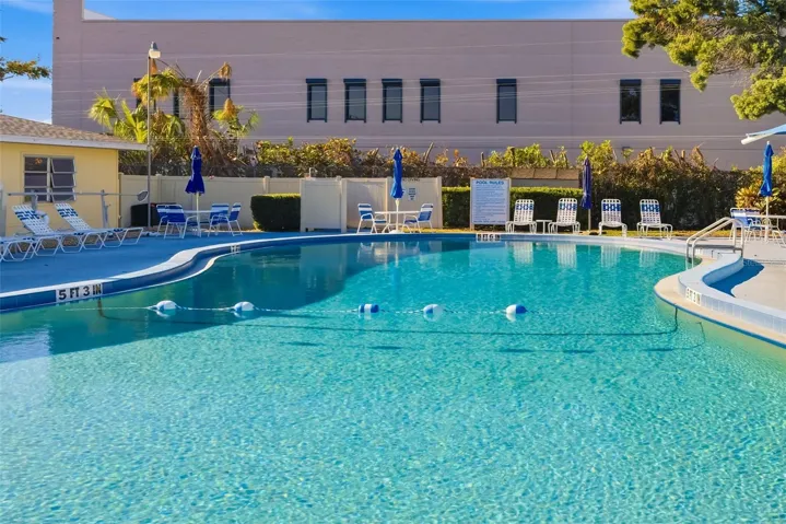Heated community pool with lounge seating – perfect for relaxing in the Florida sunshine