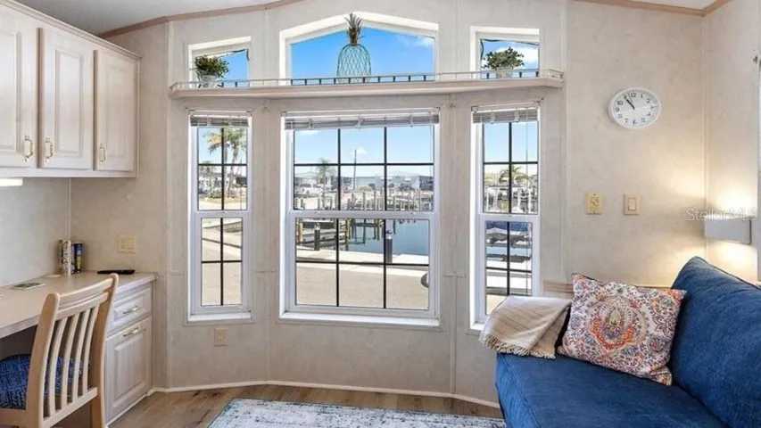 Bright waterfront living space with panoramic canal views and direct access to private dock and boat lift.