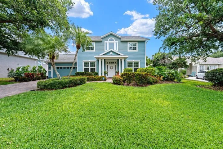 Lush grass and paver driveway and walkway