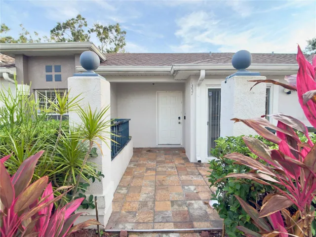 Front door with lush landscaping