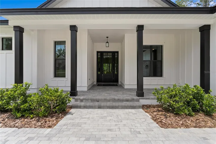 Beautiful Board and batten with long lasting Hardi Products. Paver front porch and driveway