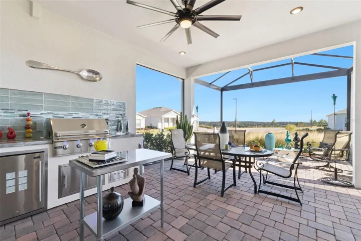 LARGE Covered Lanai with SUMMER KITCHEN with Backsplash including Grill, Outdoor Refrigerator and Storage!