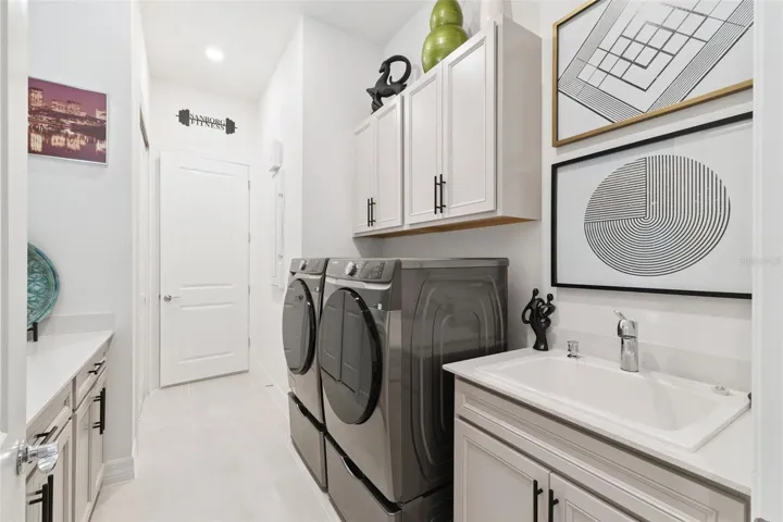 Even the Laundry Room is Amazing!  Utility Sink plus LOTS of EXTRA upgraded Cabinetry!  Finished to the same level as the rest of the House!
