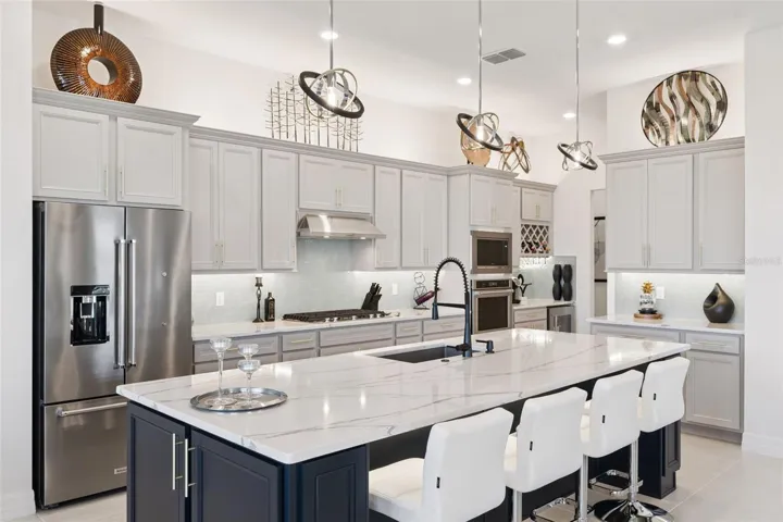 Gourmet Kitchen with UPGRADED EVERYTHING! Extended Island is OVER 10' Long!  Top of the Line Quartz and Soft Close Drawers!