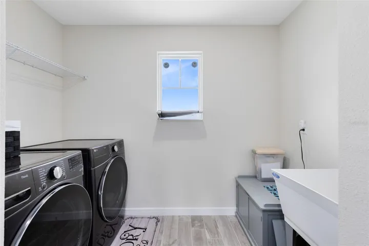 Laundry room with washer/dryer included, an equipment closet and utility sink.