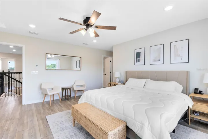 Upstairs, the primary suite includes a spacious walk-in closet and en suite bath.