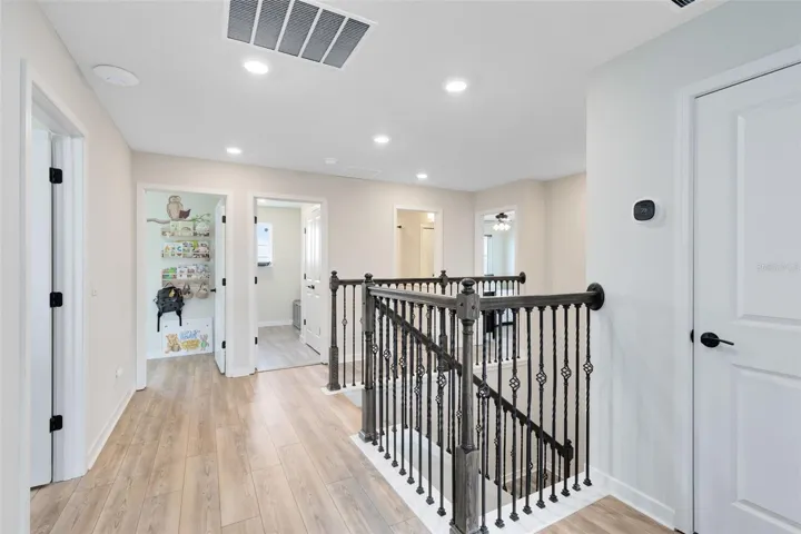 Upstairs landing. The door to the right is the upstairs AC unit. The door to the left is Bedroom 5. Straight ahead is Bedroom 4, to the right, the Laundry Room, then the Guest Bathroom and then Bedroom 3.