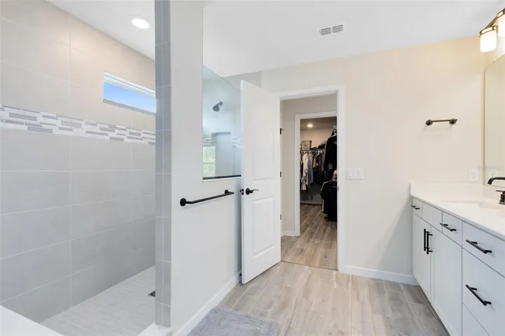 Upstairs, the primary suite includes a spacious walk-in closet and en suite bath.