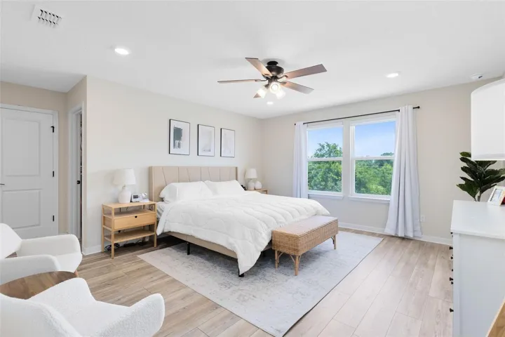 Upstairs, the primary suite includes a spacious walk-in closet and en suite bath.
