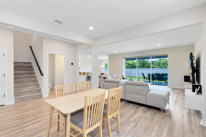 Downstairs features durable luxury vinyl plank flooring, a half bath for guests.