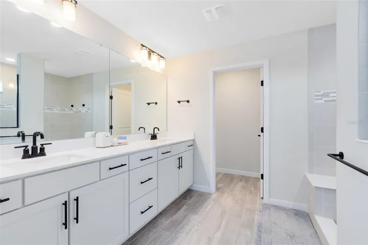 Upstairs, the primary suite includes a spacious walk-in closet and en suite bath.