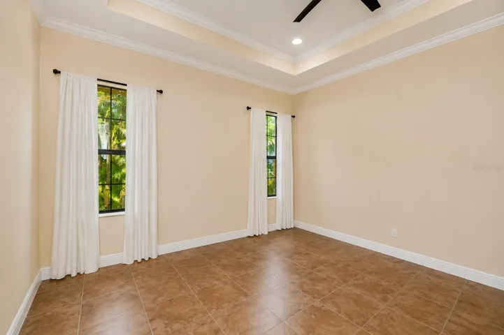 Primary bedroom, tile floors, tray ceiling
