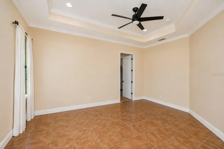 Primary bedroom with fan door to bathroom