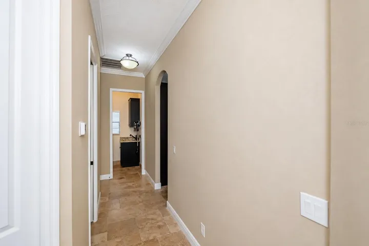 Hallway to powder room & primary bedroom