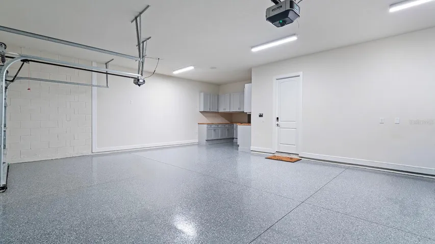Garage with Custom Cabinetss and workbench