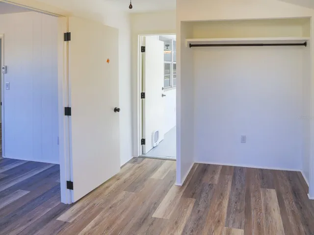 Bedroom leading towards the enclosed front porch.