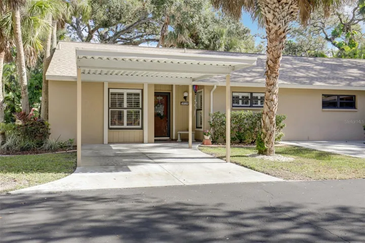 Front view with carport and second parking space to the right