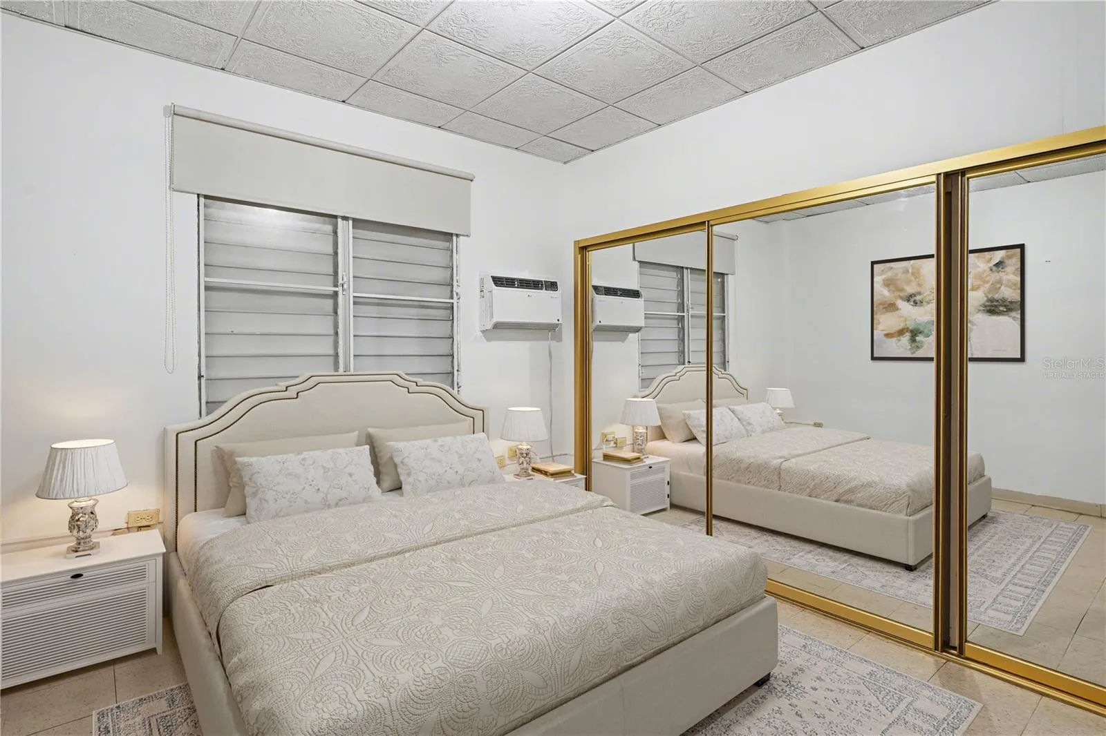 Generous primary bedroom with classic layout and renovation potential. Virtually staged.