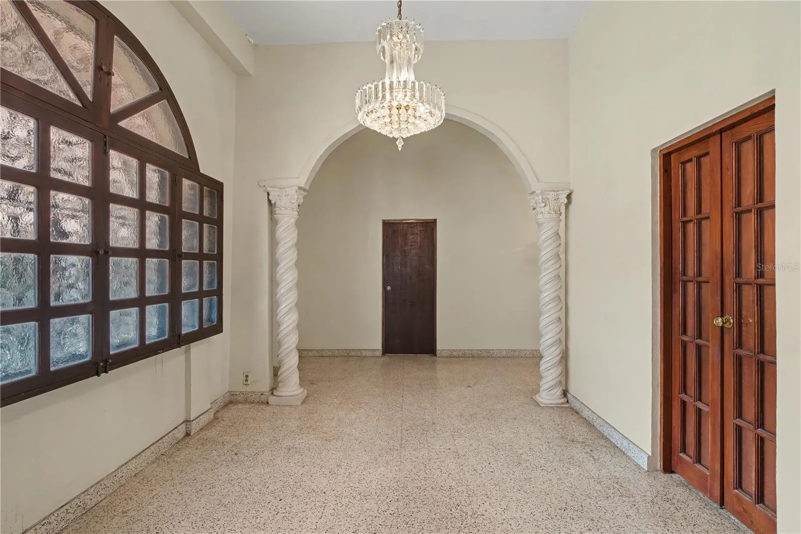 Formal reception room with arched opening and decorative columns