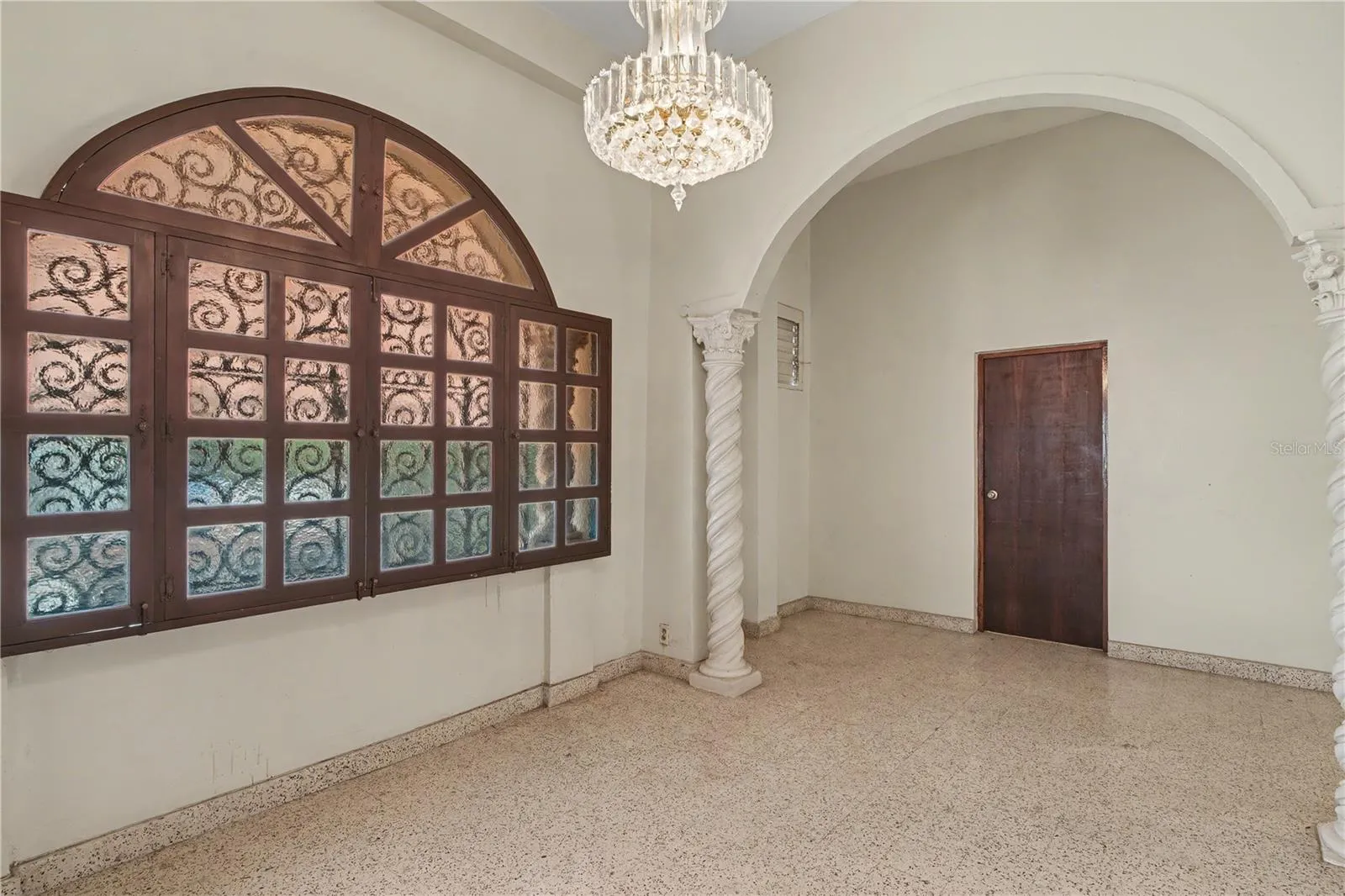 Formal living area with arched windows and original architectural details