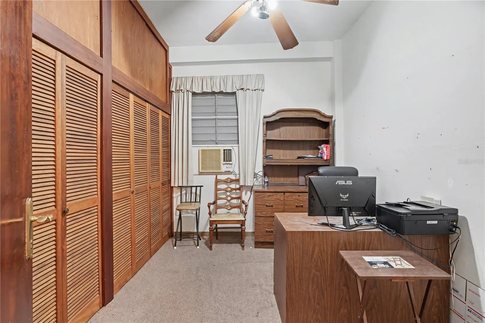 Versatile interior room ideal for private office, library, or additional living space.