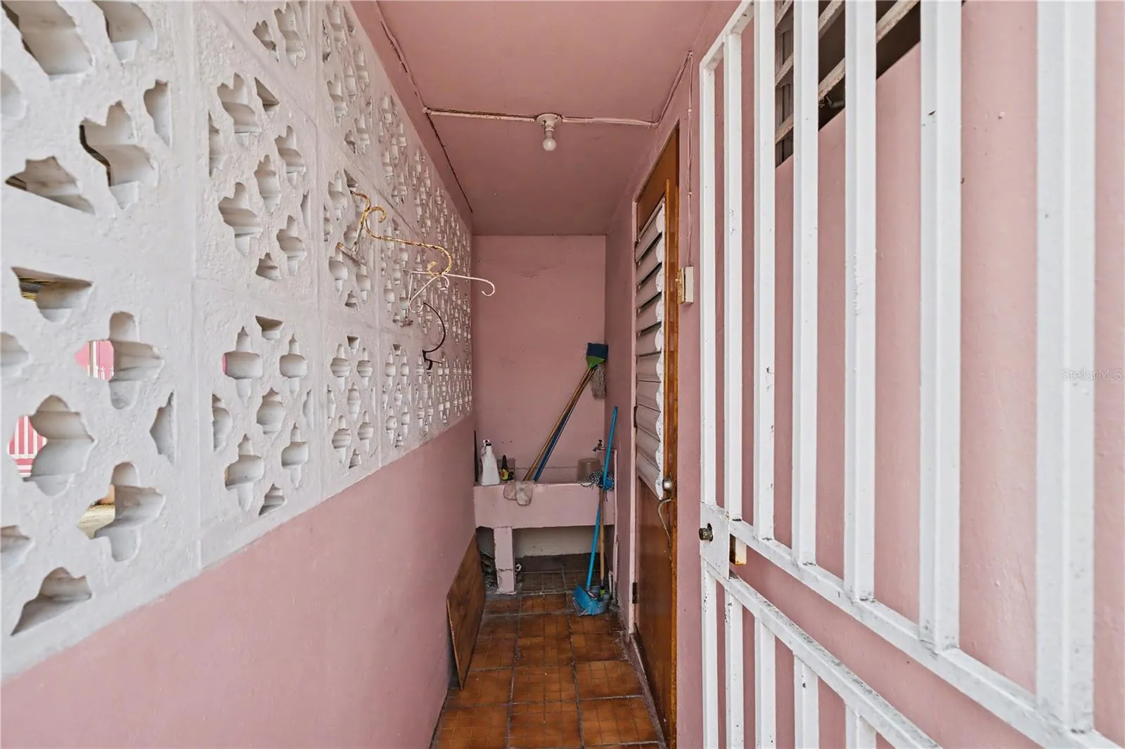 . Private corridor leading to original 1940s service quarters with independent access.