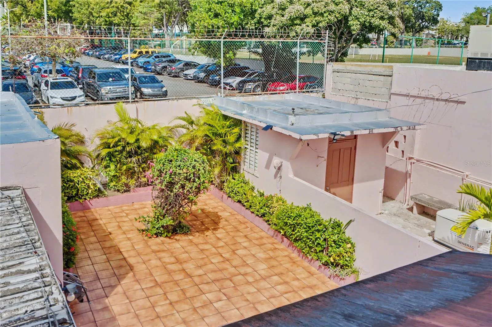 Rear terrace and service area with views toward Sagrado Corazón University
