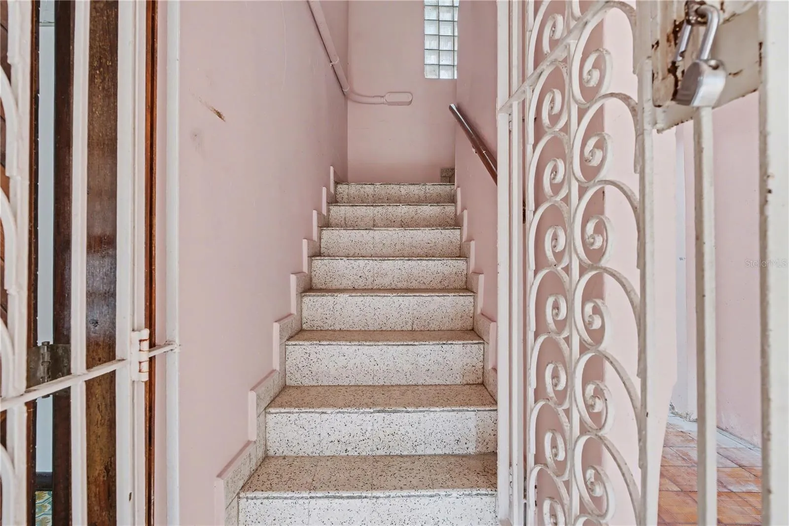 Interior stairwell connecting first and second levels with terrazzo steps