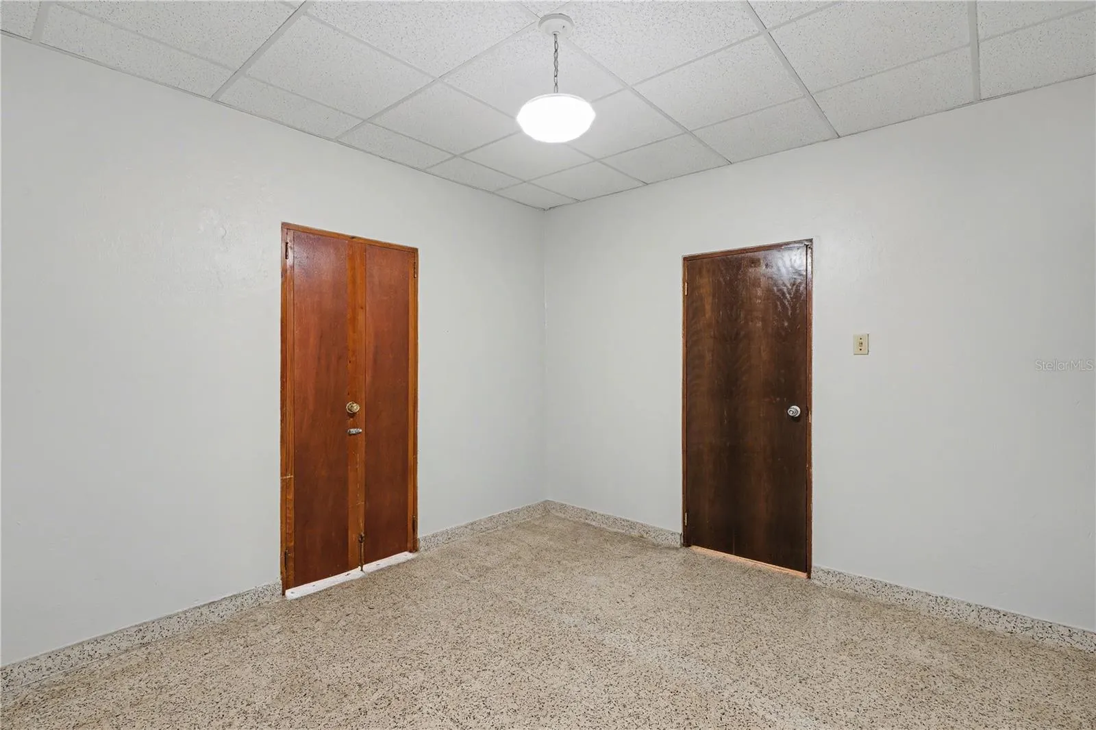 Secondary bedroom, high ceilings, and solid wood doors.