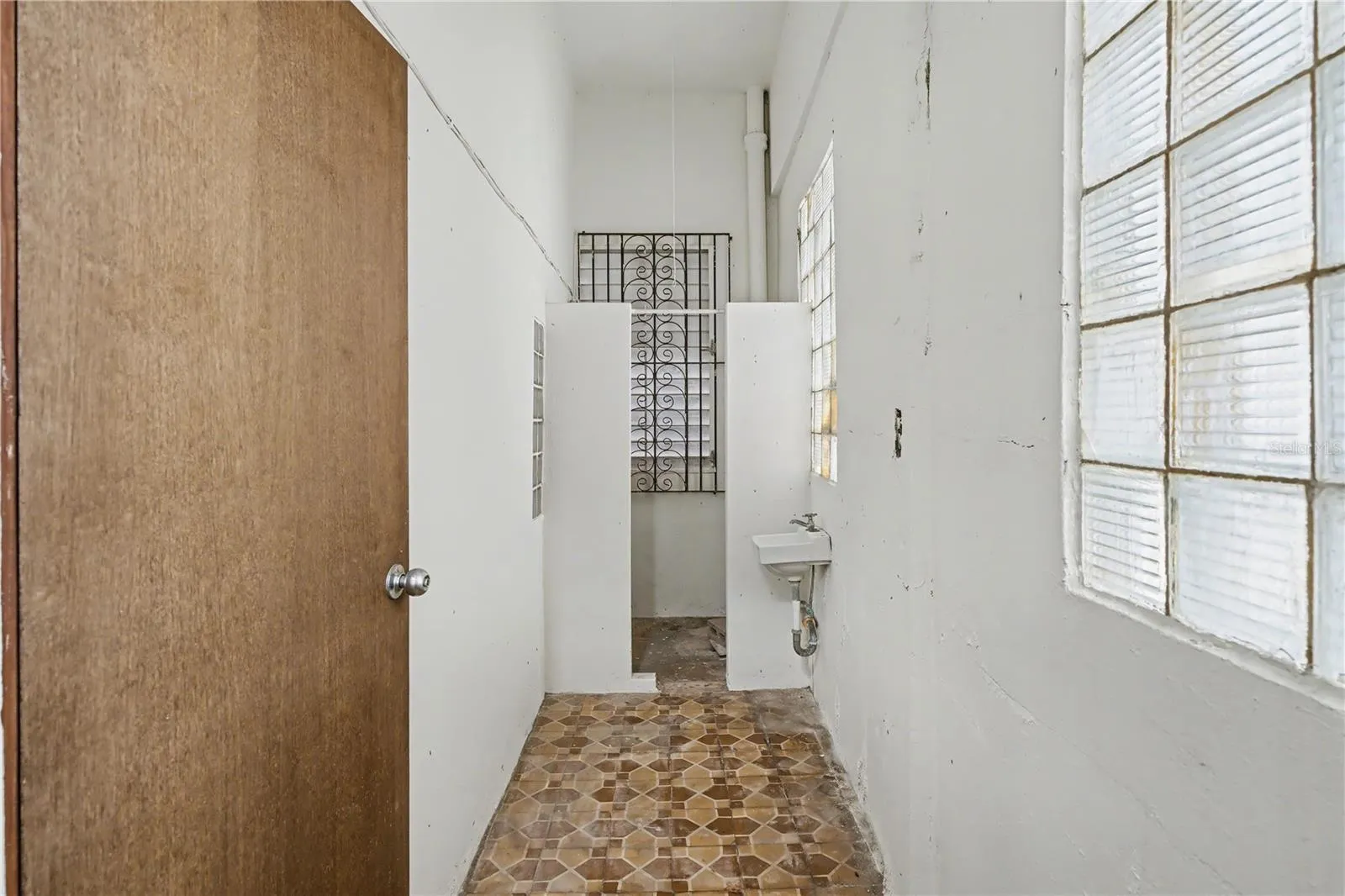 Service quarter corridor with utility sink and natural light