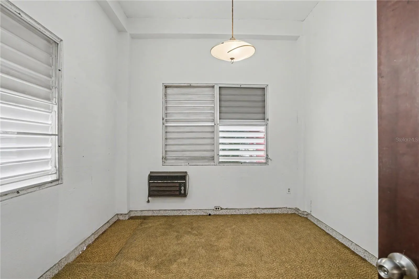 Secondary bedroom with jalousie windows