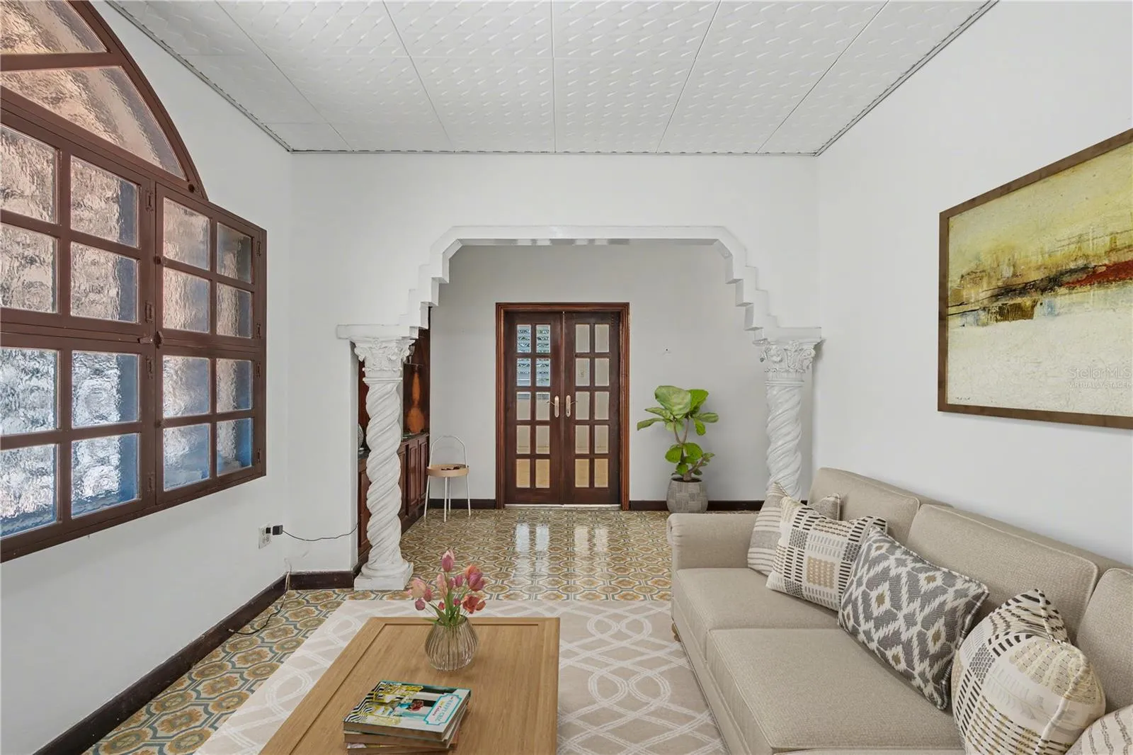 Open living area with preserved architectural design. Virtually staged.