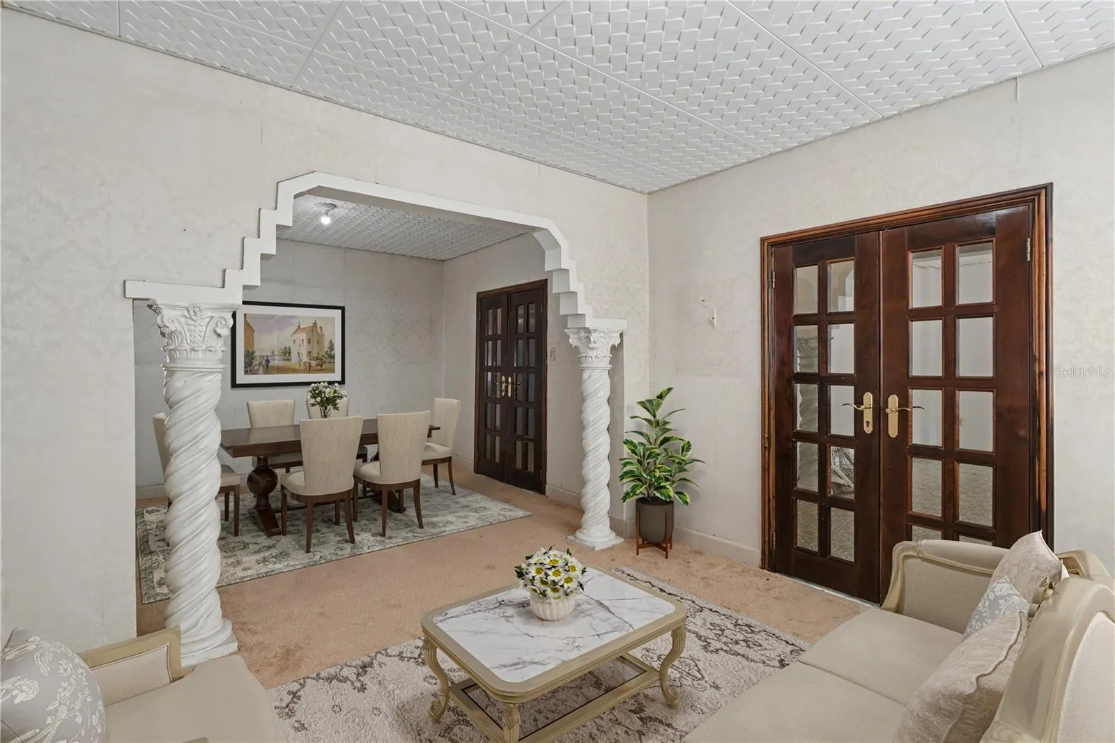 Living and dining areas connected by a signature historic architectural arch.