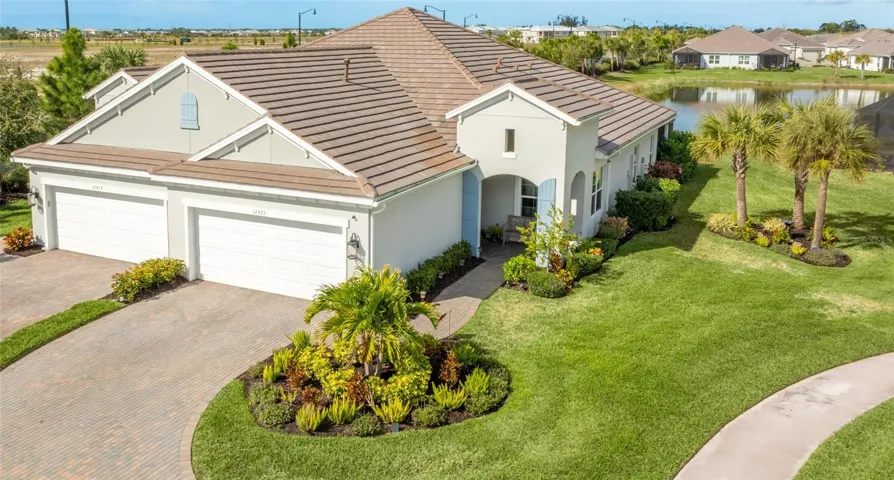 Front exterior view of Villa with upgraded Lush Landscaping and private Lot at the end of the cul-de-sac.