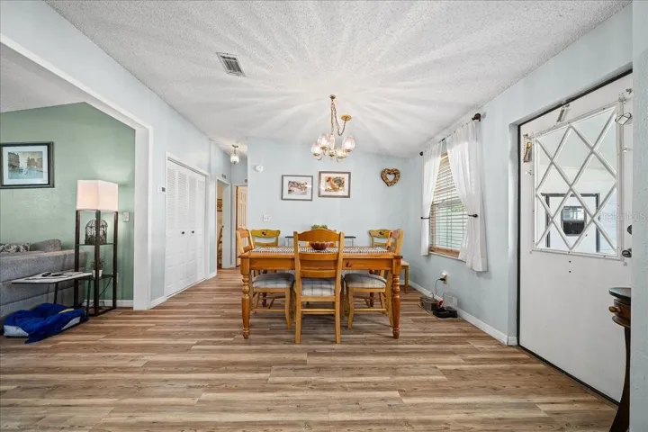 Dining Room features soothing blue walls, vaulted ceilings, and a large storage closet