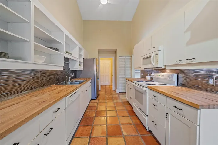 Closet pantry in kitchen and laundry room just beyond kitchen