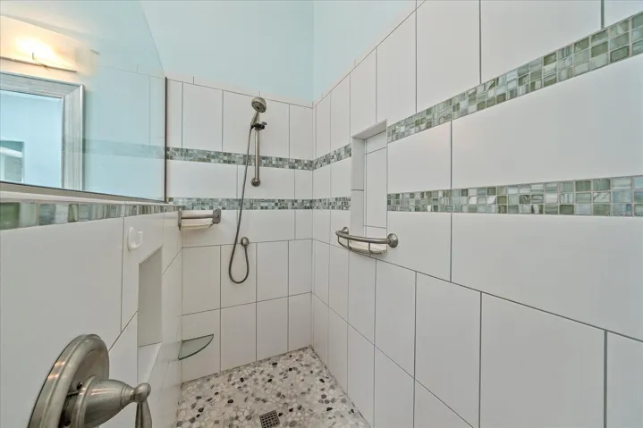 Walk-in shower with multiple grab bars