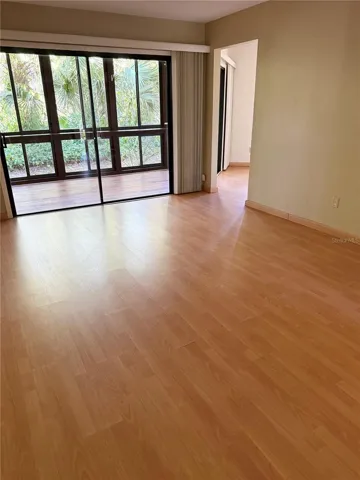 Living room to sliders to Florida Room and Kitchen to the right