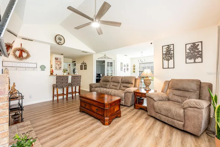 Open concept living under a vaulted ceiling.