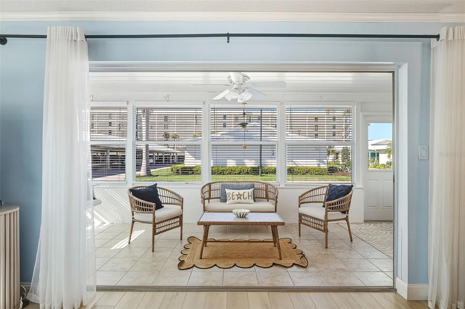 Enclosed Florida room provides extra living space with easy-care tile flooring and plentiful natural light.