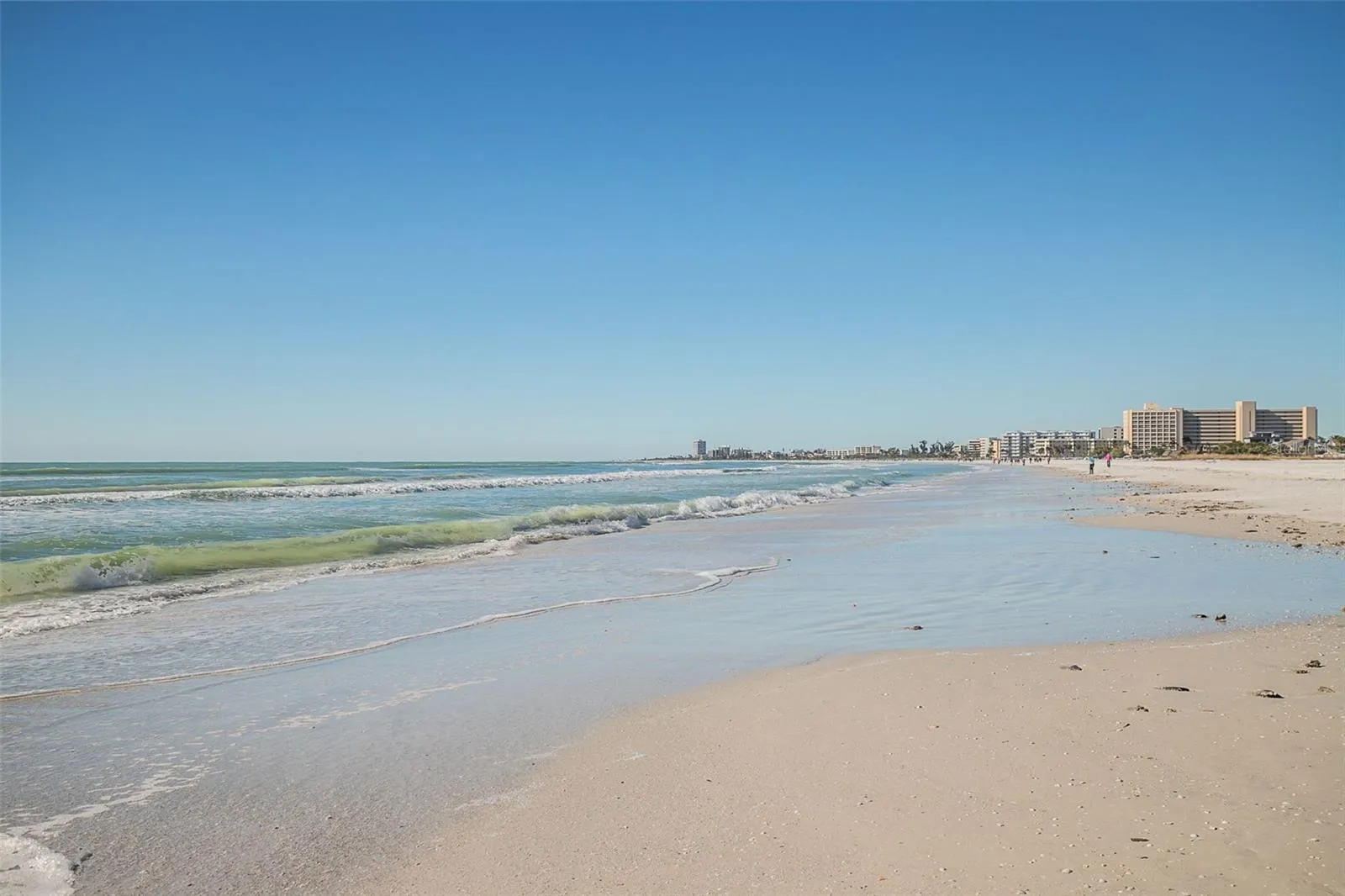Enjoy your days sitting on the white sandy beach of Siesta Key steps from this updated villa.